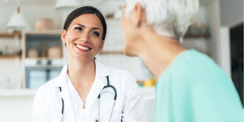 Female physician smiling with patient