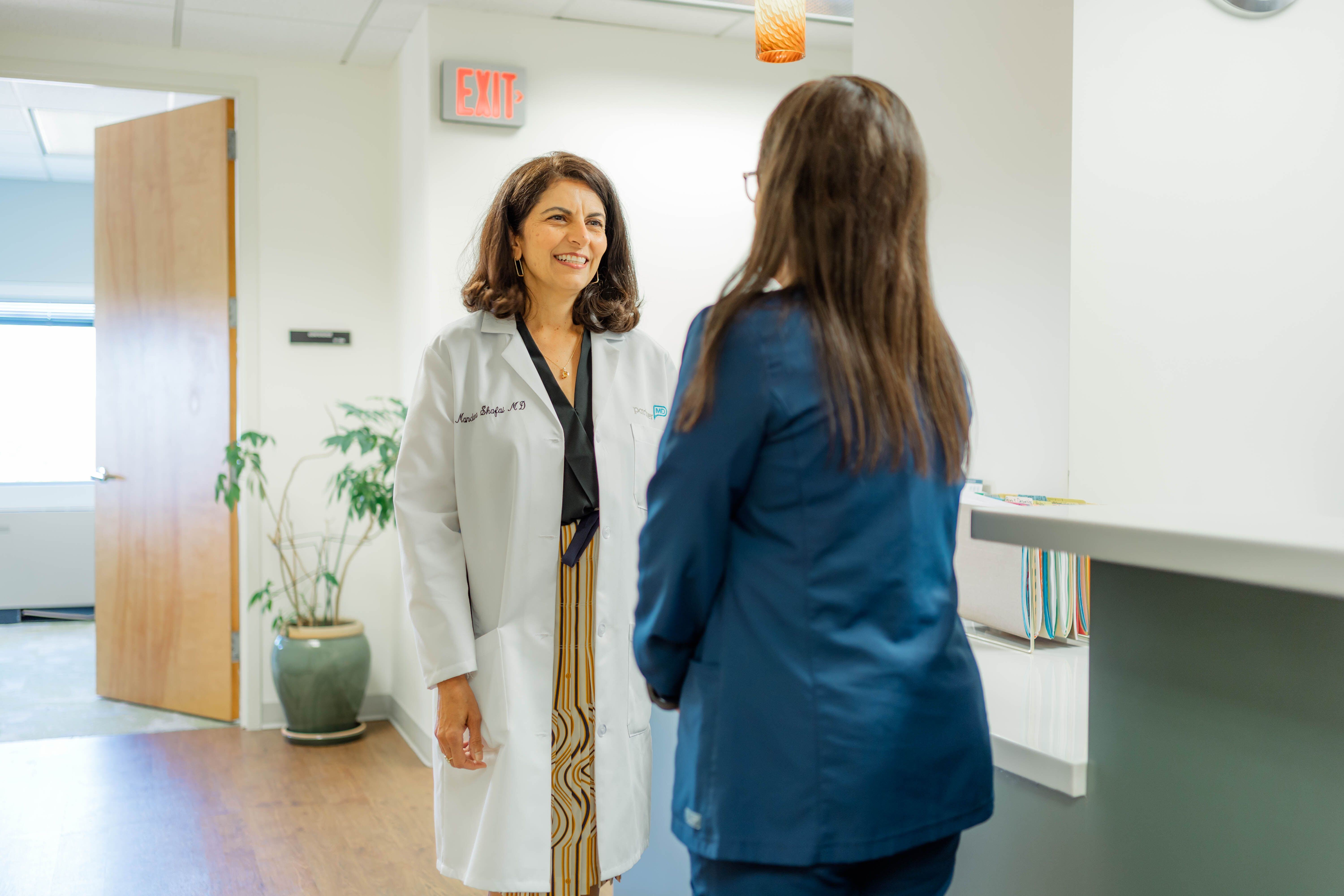 Dr. Mandana Shafai talks with a nurse at PartnerMD McLean