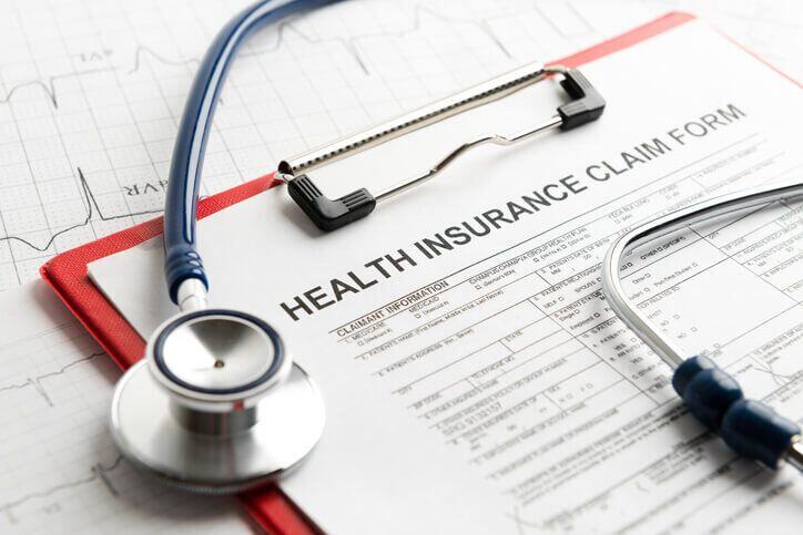 Health insurance claim form with stethoscope on top