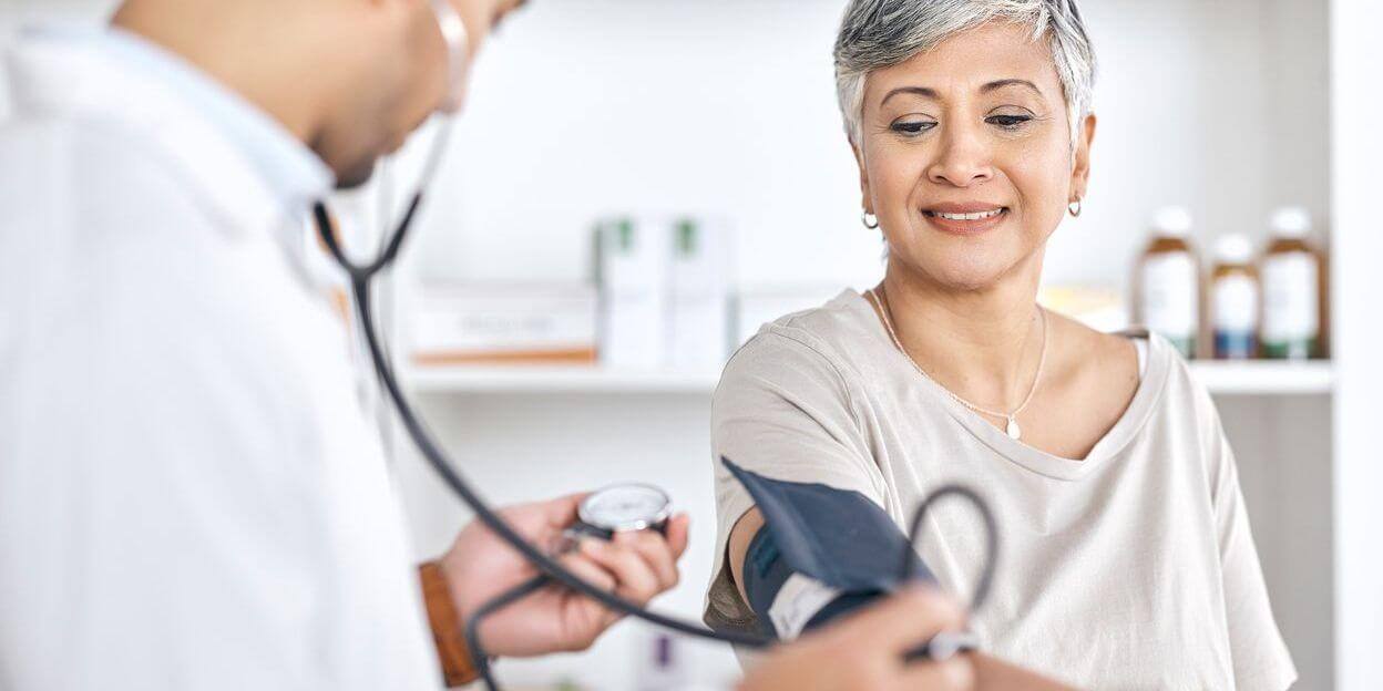 Doctor checking a patient's blood pressure. 