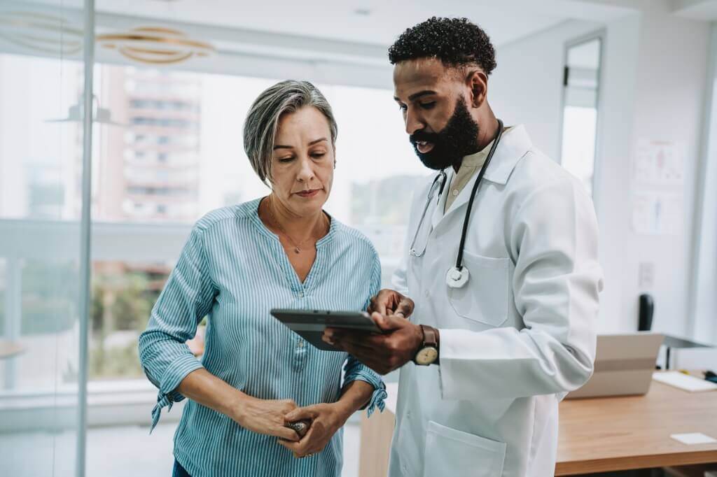 doctor and patient looking at tablet