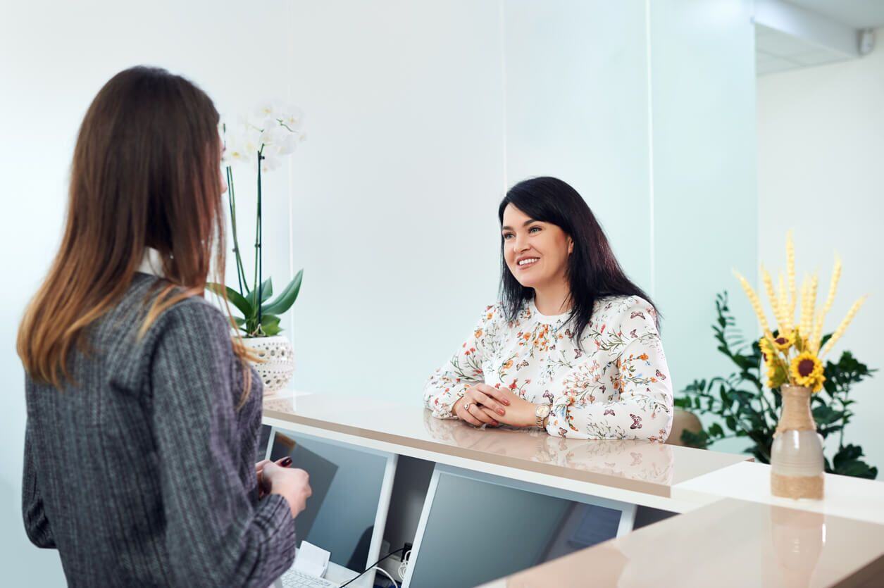 patient talking to receptionist