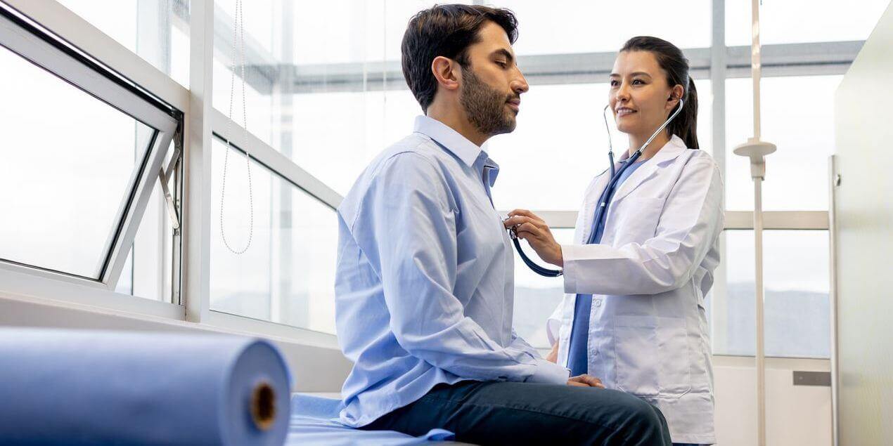 Doctor listening to a patient's heart. 