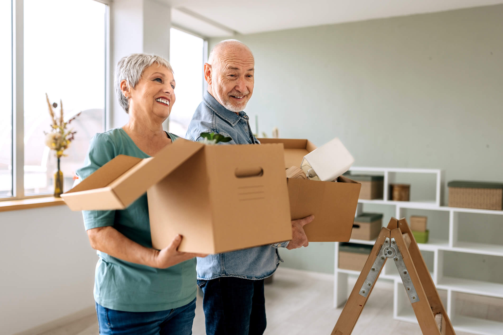 Two people packing and moving boxes