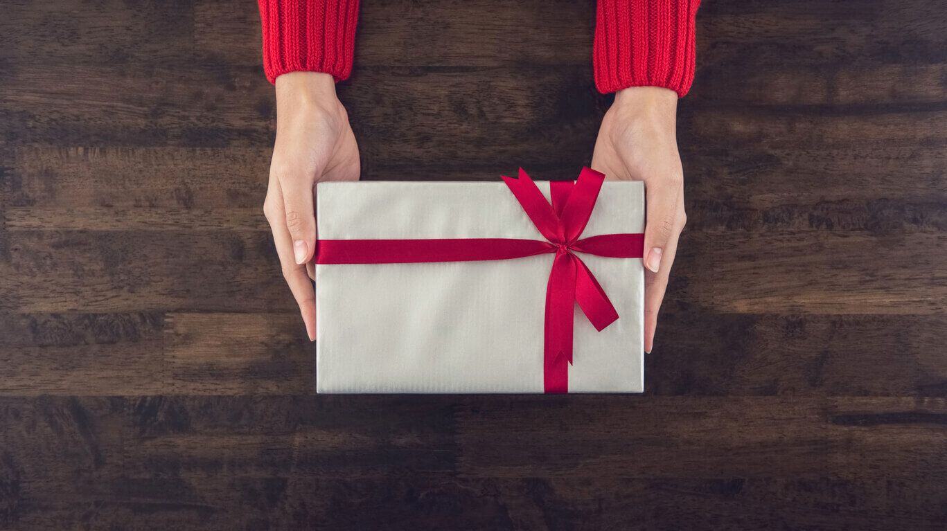 A person holding out a gift 