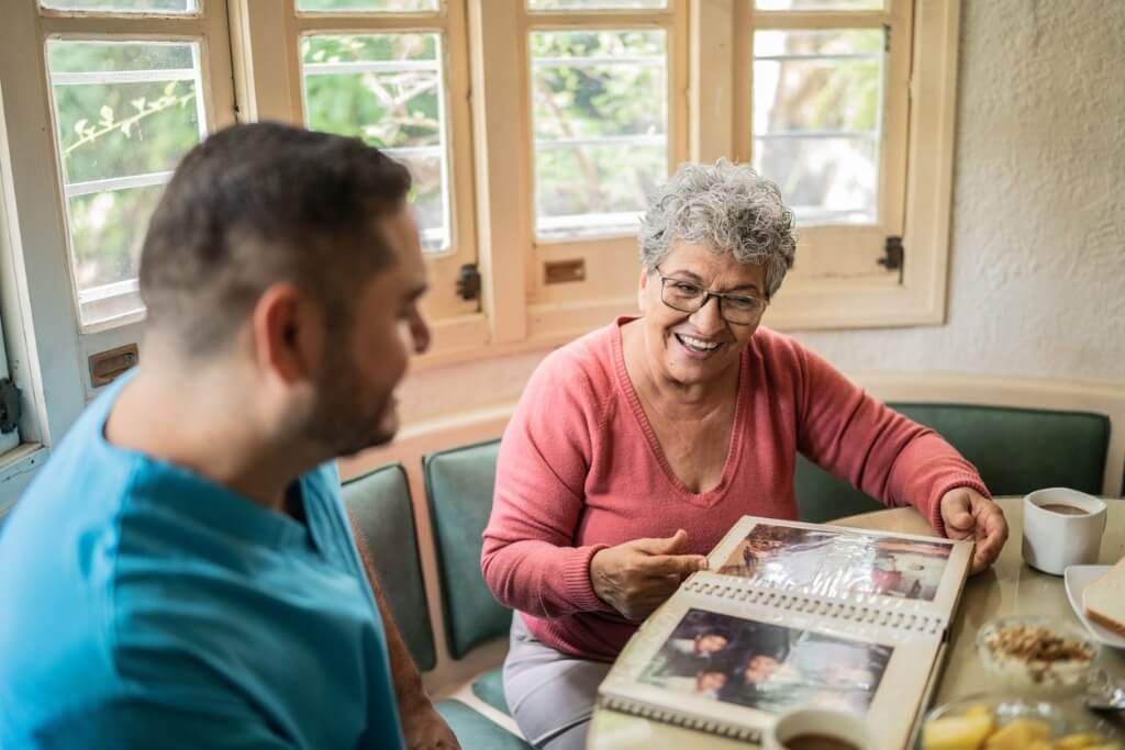 Nurse and patient looking at photo album 